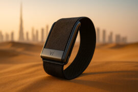 Close-up of WHOOP 5.0 fitness tracker in Dubai desert with Burj Khalifa skyline, showcasing wearable tech launch in UAE
